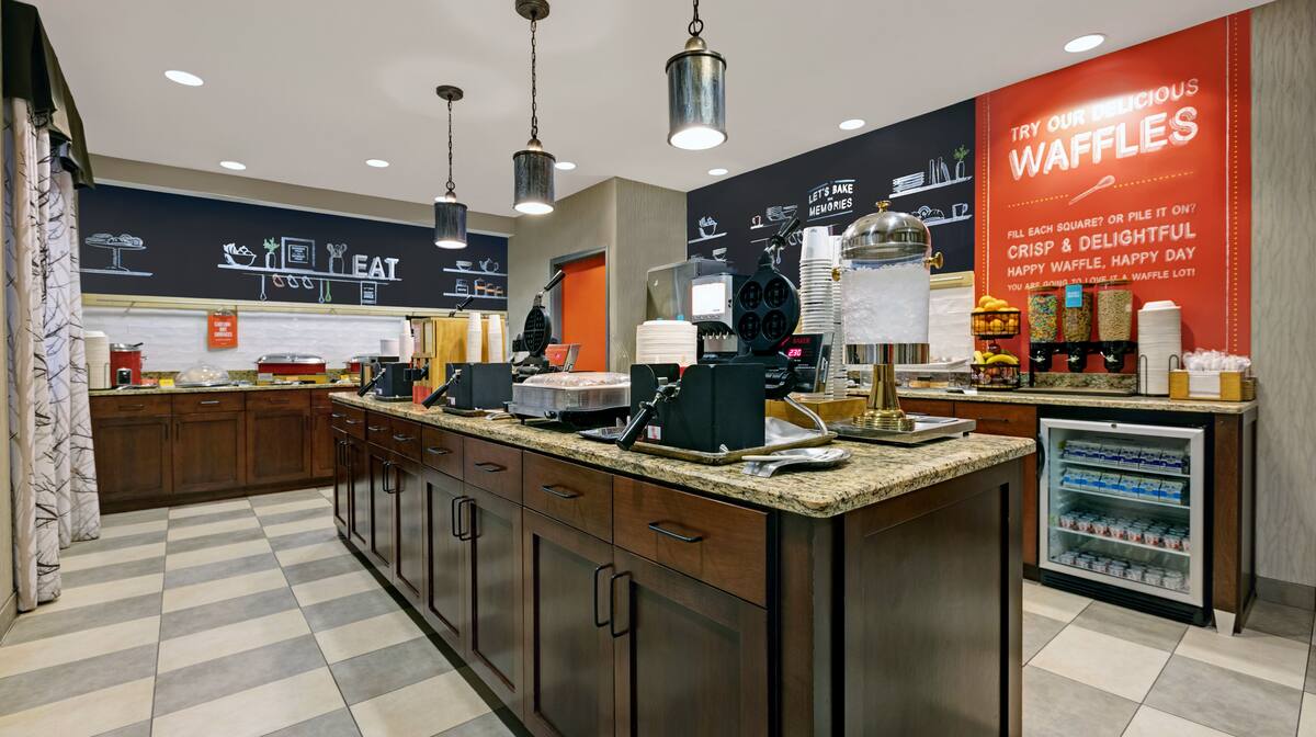 Hot breakfast buffet with eggs, waffles, and fresh fruit